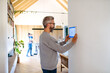 © Halfpoint - Man using smart home control panel.