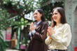 © crizzystudio - Smiling asian women performing traditional thai greeting