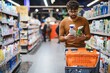 © Serhii - Arab man choosing cleaning products in supermarket