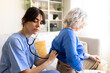 © Daniel - Female nurse examining senior woman lungs with stethoscope at home