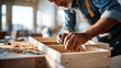 © Anastasiia Havelia - Assembling cabinet drawers on workshop floor. A carpenter puts together drawer boxes, tools scattered nearby. The sawdust and sunlight create the narrative of craftsmanship solving