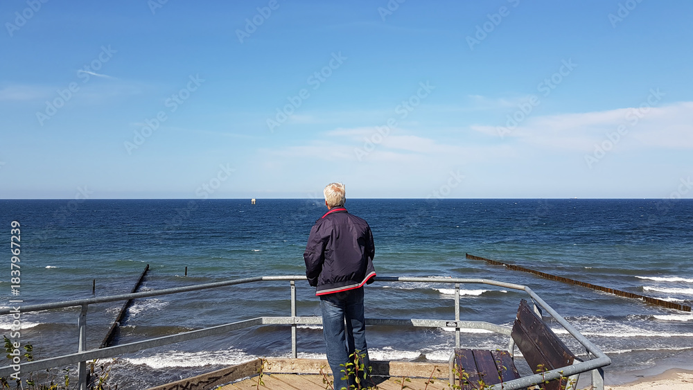 man enjoy view on the beach at beautiful day in the autumn