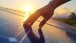 © Monmeo - Touch of Innovation: A close-up showcases a hand gently touching a solar panel, bathed in the warm light of the sun, symbolizing a future powered by sustainable energy and innovation.
