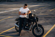 © standret - Smartphone is in hands. Man is outdoors with his motorcycle