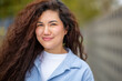 © Paula - Confident Asian woman smiling gently in close-up outdoor portrait