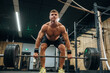 © standret - Lifting heavy barbell. Athletic man is in a gym