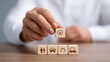 © Denis Yevtekhov - Faceless businessman putting wooden cube block stacking with insurance and assurance icon including family health real estate car financial for risk management concept, defocused h