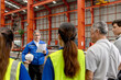 © Stella - Supervisor of diverse engineers briefing his team before working in manufacturing factory. Leader giving a briefing to team in industrial site. Worker manager conducting a site meeting in a factory.