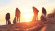© tashechka - Volunteers collect trash along the beach during sunset
