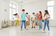 © Studio Romantic - Group of pupils or students spending leisure time together during a break in the school classroom, playing and enjoying themselves. Fun and happiness of children relaxing together.
