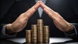 © thanawat - Hands protectively cover a stack of coins, symbolizing financial security and investment in a dramatic lighting setting.