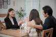 © surachetkhamsuk - Asian financial consultant explaining new project investment to young couple in office. Real estate agent discussing mortgage options with family. Mortgage loan consultation.