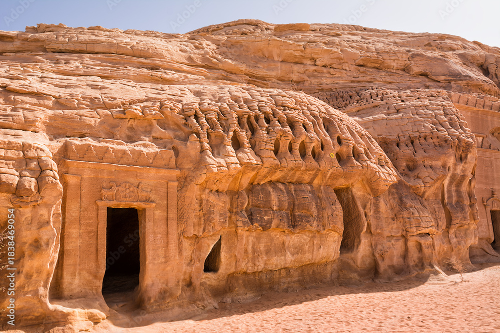 Portal of Nabataean rock cut tombs carved into the mountain face at the ...