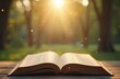 © Pete - Open book on wooden table outdoors. Sunshine illuminates pages creating warm light. Concept of learning education. Nature background adds a touch of peace. Ideal for stories.