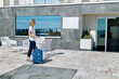 © Caterina Trimarchi - Businesswoman with suitcase entering in hotel.