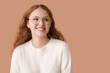 © Pixel-Shot - Portrait of ashamed young woman on brown background