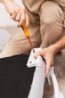 © Aboltin - Focused on task, man works on connecting chair components, close up hands using screwdriver to secure each element. Home environment emphasizes practical skills and everyday problem-solving.