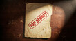 © sxcd - Top Secret Stamped Old File Folder on Wooden Desk