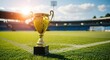 © Nina - Golden soccer trophy standing proudly on a vibrant green football field inside a large stadium under a bright sunny sky, symbolizing victory and championship success.