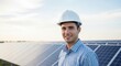© Lumora - Happy male engineer in white helmet stands near solar panels outdoors on a sunny day