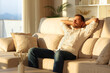 © Antonioguillem - Relaxed man at sunset at home resting sitting on a sofa