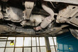 © Борис Бондарчук - The process of draining used oil from the engine in a car service. Changing the oil in a car.