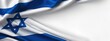© BlackLion - Israeli flag waving in the wind showing blue and white colors with a star symbol during bright daylight outdoors
