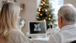 © photo for everything - An expectant couple reviews their ultrasound during the holidays. A doctor is present to guide them. Christmas tree in the background to remind them the holidays are near!
