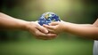 © detiyy - Hands holding Earth globe representing care