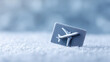 © Nakarin - Frozen credit card with airplane model on snowy surface, symbolizing winter travel and cold weather finance