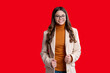 © be free - Autumnal fashion and teen style. Fall season style. Back to school. Teen girl in autumn fashion style. School time. Teen girl isolated on red. Girl wearing autumn coat. Copy space