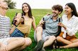 © Xavier Lorenzo - Happy young millennial group of diverse friends cheering with google beers and social gathering together at city park. Meeting and reunion concept