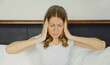© rohappy - Exhausted tired woman suffering from headache, stress, fatigue, temples pain, migraine, loud noise