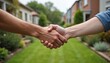 © Viktor - Two people shake hands in front yard with green grass, houses in background. Neighbors agree, cooperate, resolve dispute. Hands clasped together in sign of mutual respect, understanding. Friendly