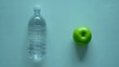 © Vitalii - Bottle of sparkling water and green apple
