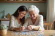 © Viktor - Woman plays jigsaw puzzle with senior mother in bright kitchen. They smile, enjoy time together. Family connects with game, having fun in retirement at home with cognitive activity.