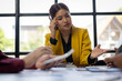 © Wasan - Stressed businesswoman having problems and discussing with her colleagues during corporate meeting.