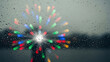 © JKT - Colorful light streaks burst through rain drops on a dark window creating bokeh effect