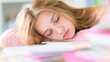 © tashechka - Young girl sleeps on desk while studying in bright room during daytime
