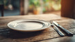 © Dmitry - Empty plate and silverware on an old wooden table. Concept of poverty, hunger, and food insecurity for social issues illustration.
