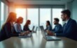 © Jacob - Blurred view of a modern office meeting room with people working on laptops, creating a professional and focused atmosphere. High quality