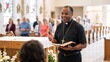 © Vasiliy - A smiling African American priest gives a sermon in church. Joyful black pastor preaching to the congregation and holding a bible