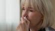 © Yuliia - Portrait ill old Caucasian woman spraying nose with nasal spray remedy allergy sneeze senior female retired granny lady unhealthy medicine health care sneezing at home medication allergic symptoms