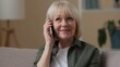 © Yuliia - Old Caucasian woman talking mobile phone call with grandchildren in apartment talk smartphone smiling carefree cheerful retired female senior grandmother communicating conversation friendly at home
