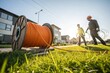 © shahjalal - Construction site with fiber optic cable installation. Workers and heavy machinery lay underground cables for high-speed internet, broadband communication, and modern network infrastructure.