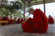 © Travel 'n' Lifestyle - Punakha, Bhutan - 19 September 2025: View of crimson-robed nuns in Wolakha Nunnery, heads bowed in prayer, their fans and books a pale contrast to the vivid red under a simple roof.