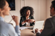 © Jelena - Professional Woman Leading a Business Meeting in Office Setting