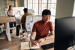 © Jelena - Professional Team Collaborating in a Modern Office Environment