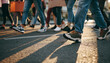 © devilvet - Low angle view of people walking together on sunlit city street casting long shadows symbolizing movement unity and public action