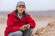 © Gatherina - Woman researcher holding a tortoise during field conservation work